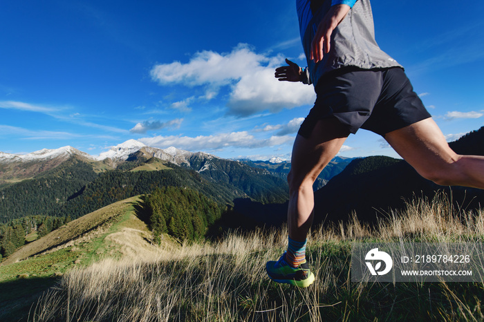 Detail of mountain runner legs during a downhill workout