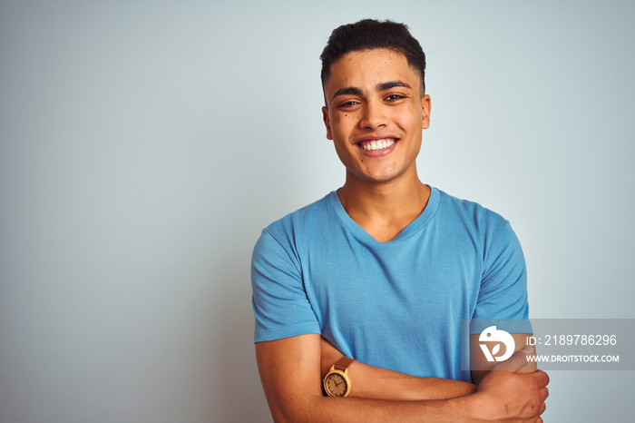 Young brazilian man wearing blue t-shirt standing over isolated white background happy face smiling 