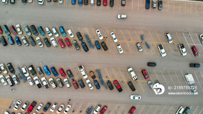 Aerial view of cars at large outdoor parking lots, USA. Outlet mall parking congestion and crowded p