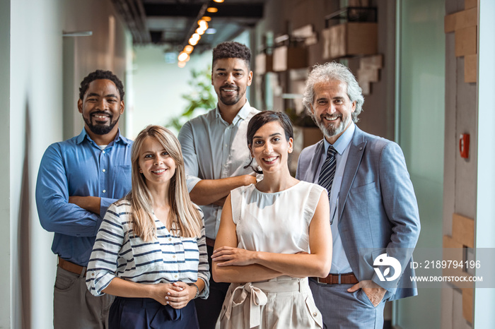 Smiling professional business coaches leaders mentors posing together with diverse office workers in