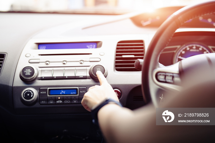 woman push turn on music radio in car