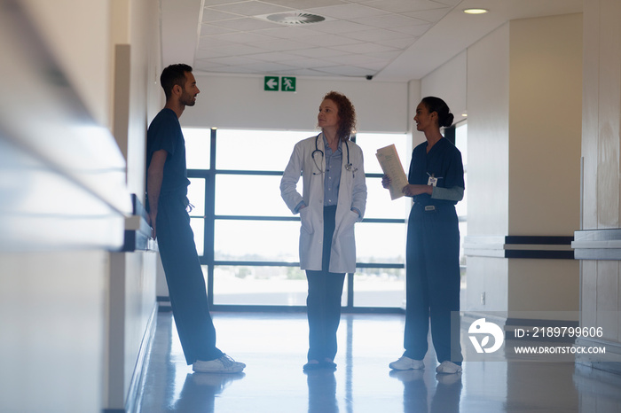 Doctor and nurses consulting in hospital corridor