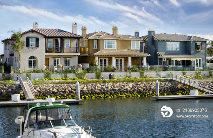 One story houses in a row with lake in foreground