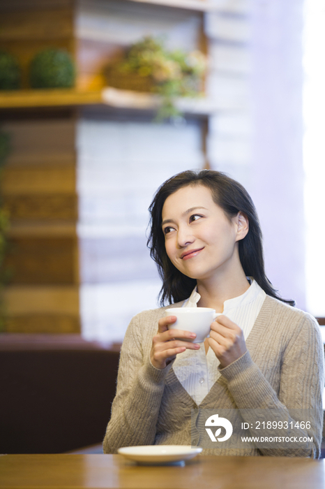 年轻女子在咖啡馆喝咖啡