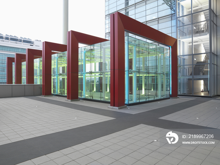 Red framed glass structure at courtyard in modern office building