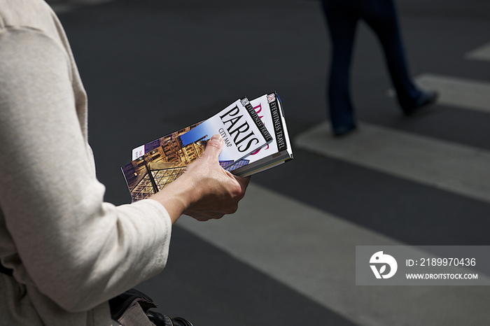 A woman holding guidebook in Paris,France