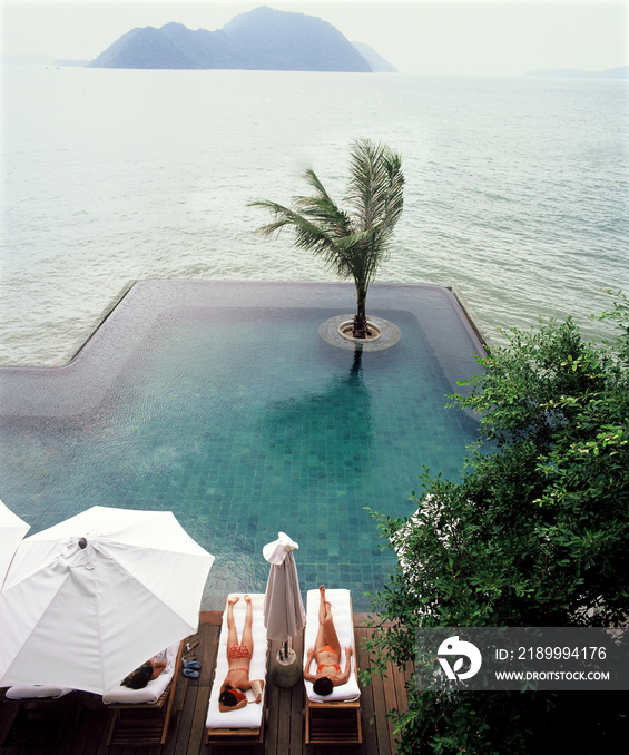 Two women lying nearby swimming pool, Evason resort and Spa, Pukhet, Thailand