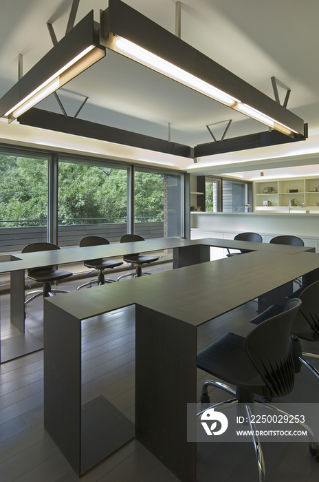 Fluorescent light hanging above modern conference table in office