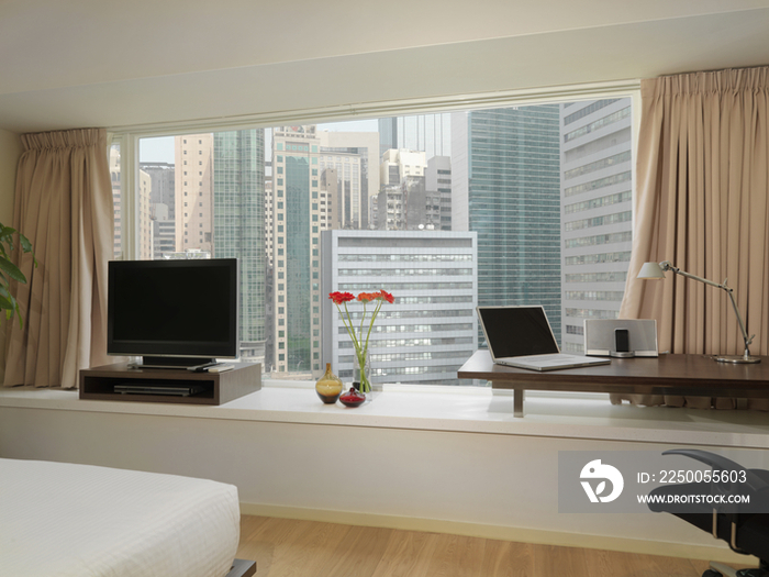 View of modern buildings through glass window of house