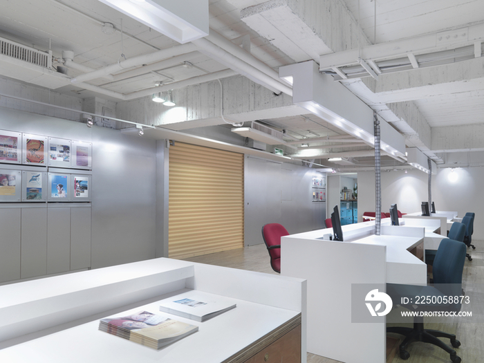 Row of desks and chairs in office