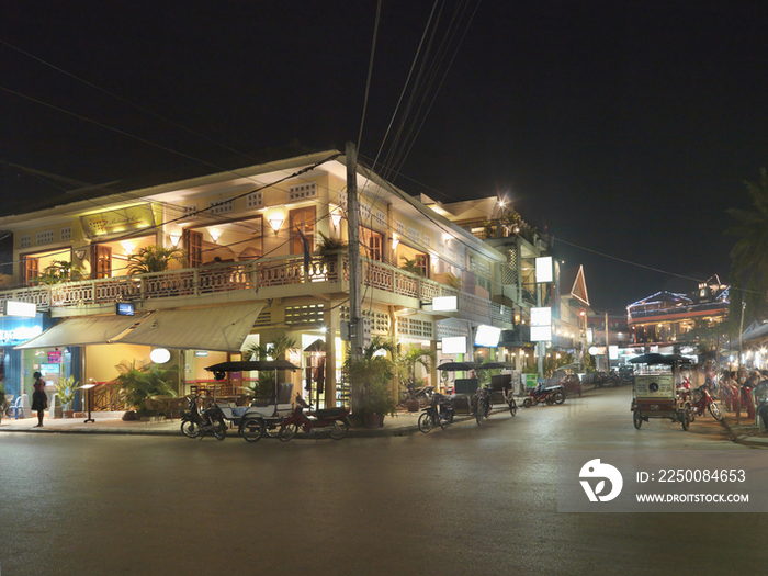 View of street by residential building at night