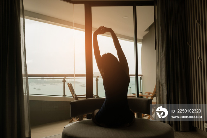 A woman sitting on the sofa and looking at the sea, relax time, girl resting