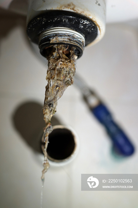 Close up of clogged kitchen sink pipe.