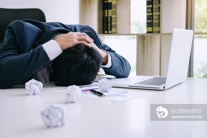 Feeling stress and headache, Businessman depressed and exhausted at his desk frustrated with problem