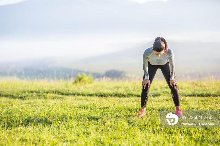 Young woman athlete runner tired breathing after running