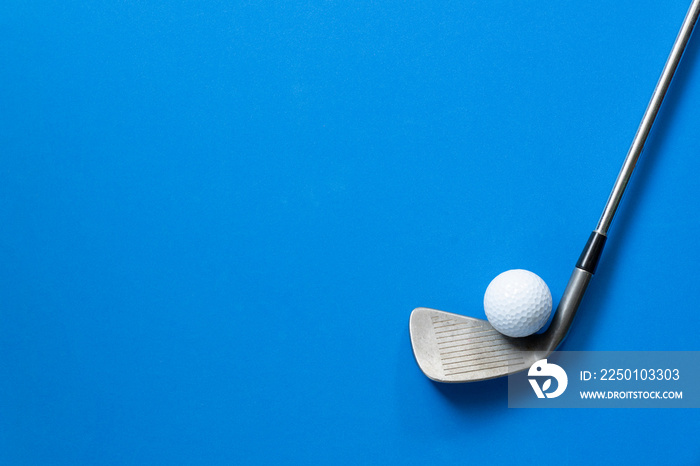 golf ball and golf club on blue background