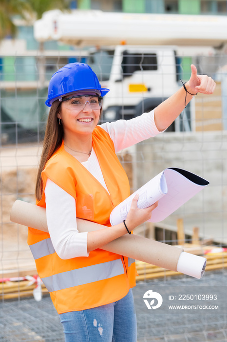 Beautiful architecture student doing a thumbs up gesture