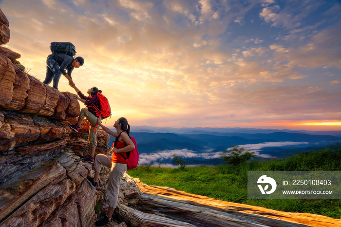 Hikers walking with backpack on a mountain at sunset. traveler going camping. travel concept.