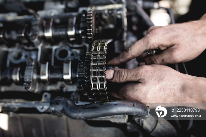 Car service worker working on automobile engine repair