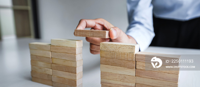 Plan and strategy in business, Risk To Make Business Growth Concept With Wooden Blocks, hand of man 