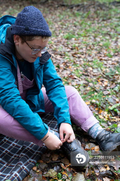 Female hiker tying hiking boot