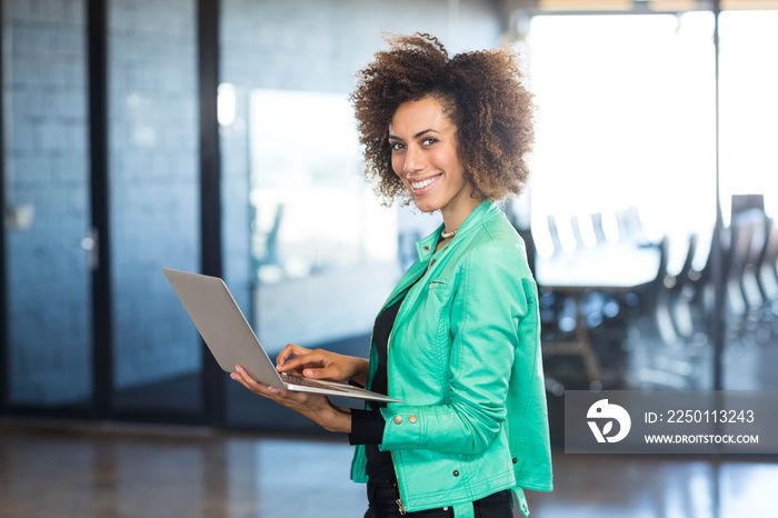 Young woman using laptop in office