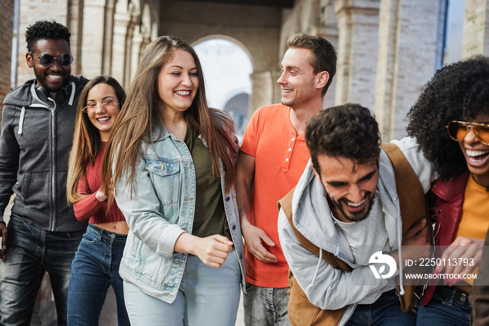 Young multiracial people having fun outdoor in the city - Focus on center girl face