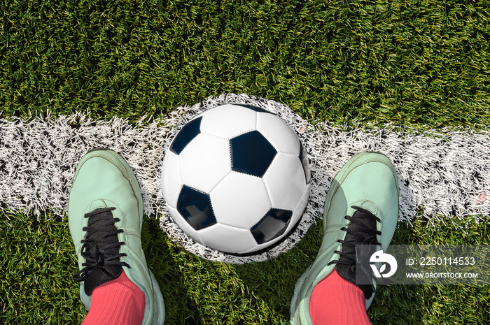 Shot of a soccer player standing on the field with ball on the center of soccer fieldfield