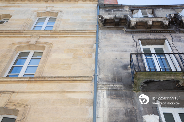 before and after between a wash cleaned house facade and a dirty one in a city center