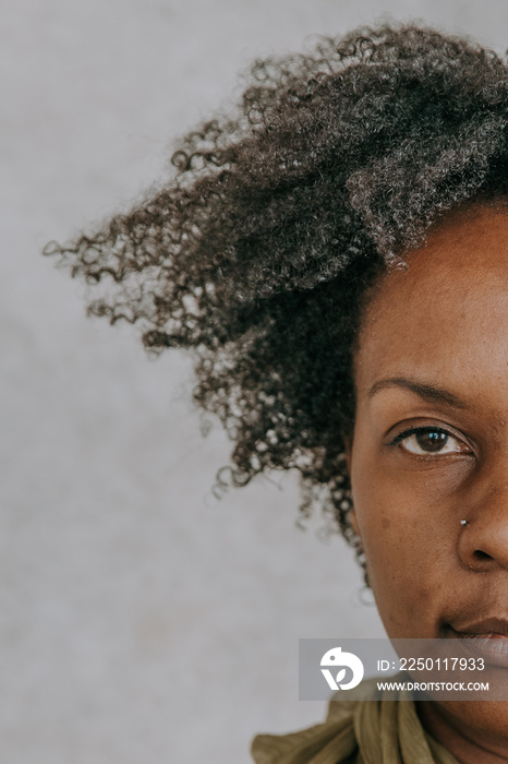 close up of African American woman with afro half face