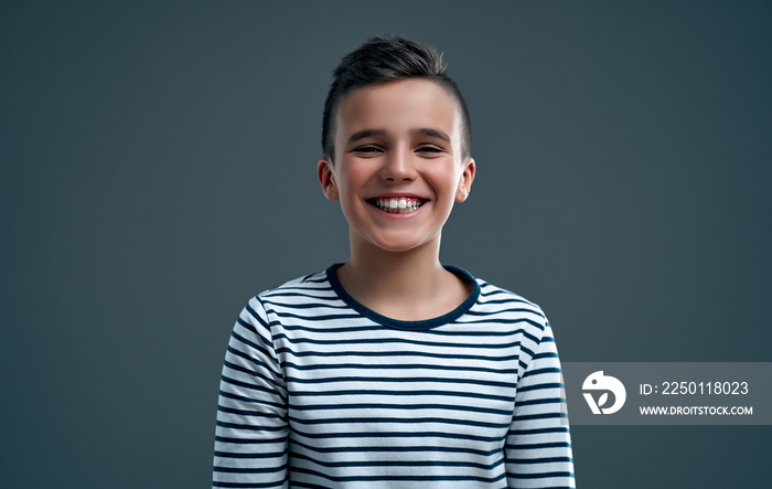 Fashionable boy on a gray background