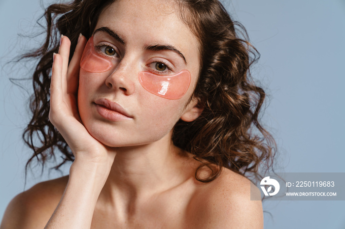 Beautiful half-naked nice girl posing with eye patches