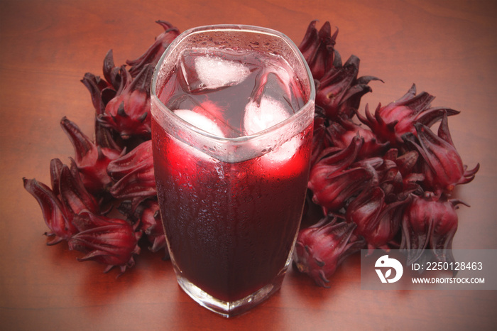 Hibiscus sabdariffa or roselle flowers cold tea on wooden table