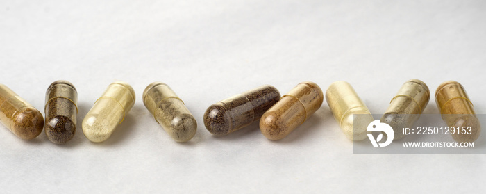 Various medical capsules on a white surface