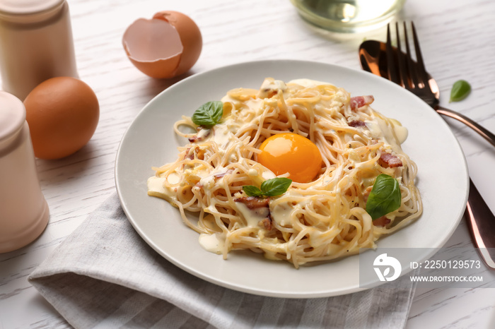 Plate with delicious pasta carbonara on table