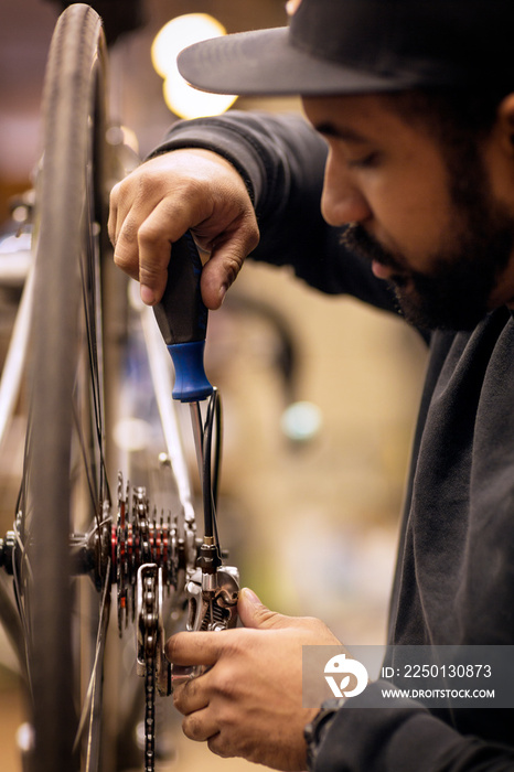 Mid-adult man repairing bicycle