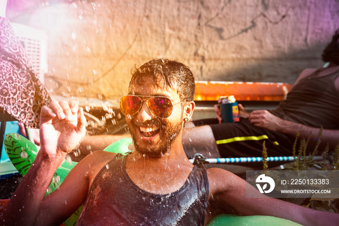 Man in sunglasses being splashed