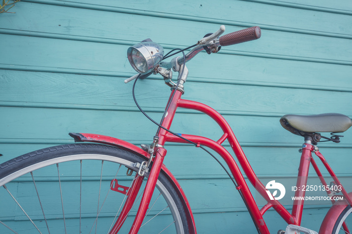 red vintage bicyle parking on blue wooden wall