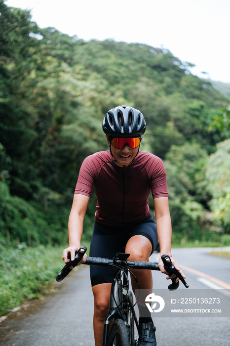 A young female cyclist emotional while riding her bike