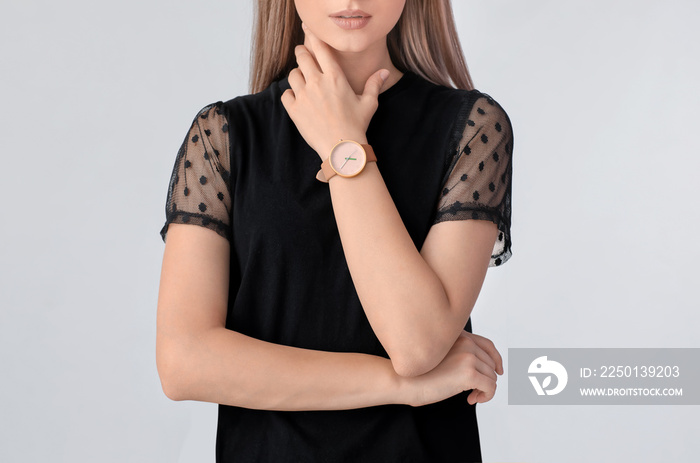 Woman with stylish wrist watch on white background