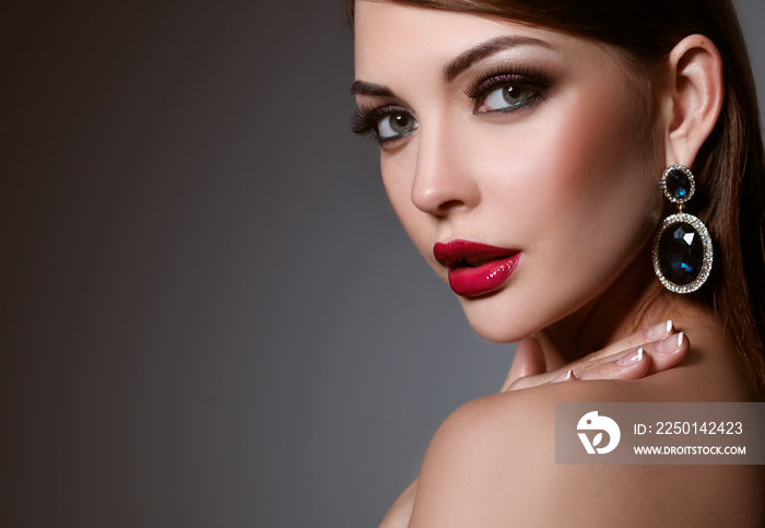 Portrait of beautiful young brunette woman in ear-rings