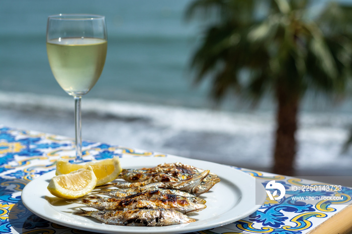 Espeto, Malaga style fish on stick barbecue prepared on olive tree firewoods and white wine