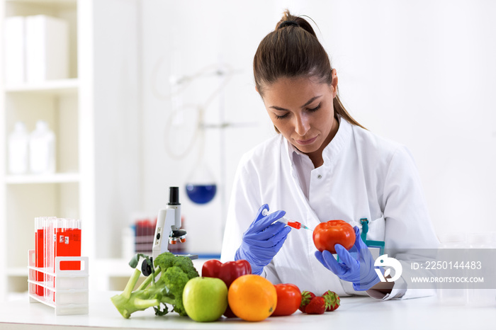 Scientist putting new sample to vegetables and cheking results