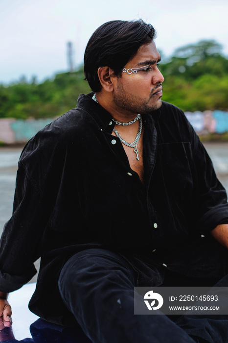 portrait of dark skinned Indian man on rooftop