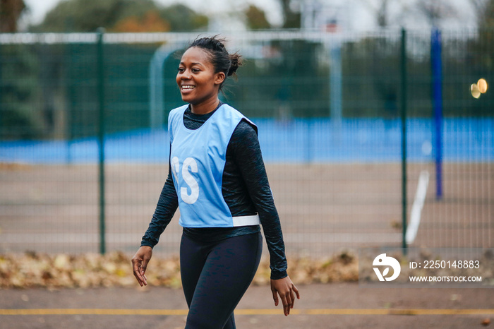 Young female netball player on netball court