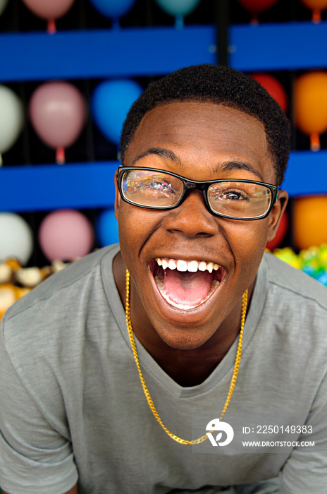 Teenage boy laughing at amusement park