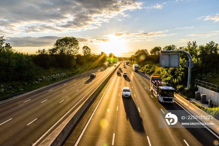 busy traffic on uk motorway road overhead view at sunset