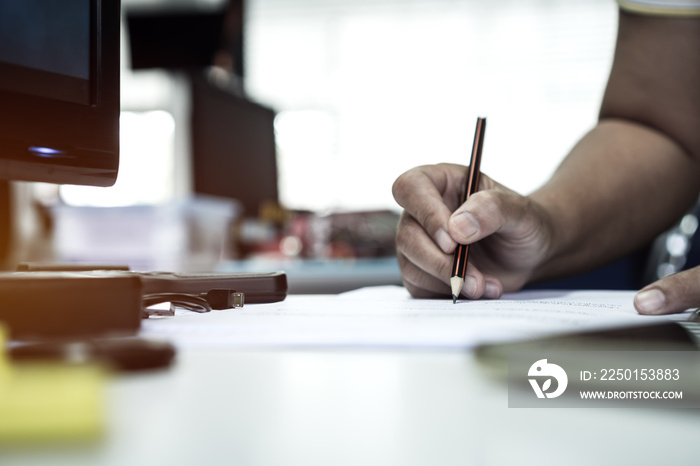 Document report and business busy concept: Businessman manager hands holding pencil for reading and 