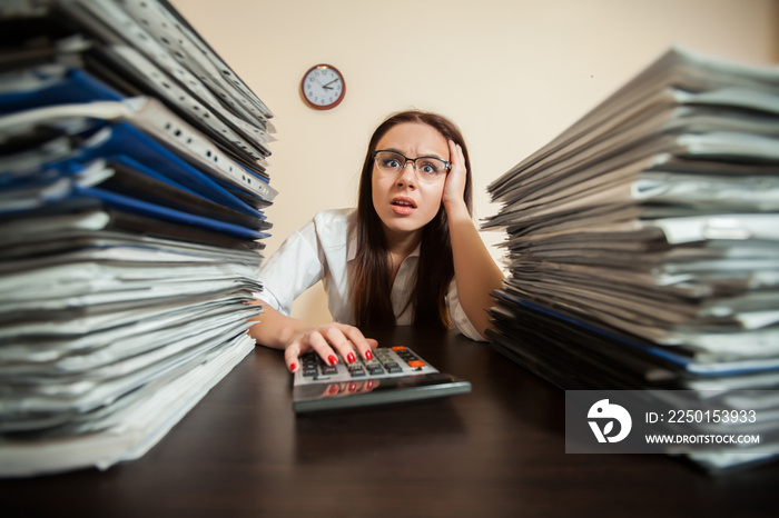 Doomed accountant against big stacks of documents