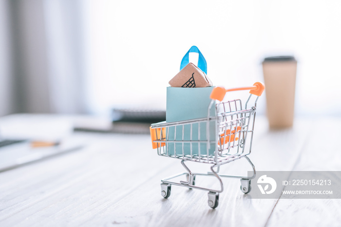 selective focus of toy cart with shopping bag